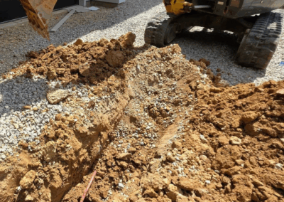tractor digging to place water line
